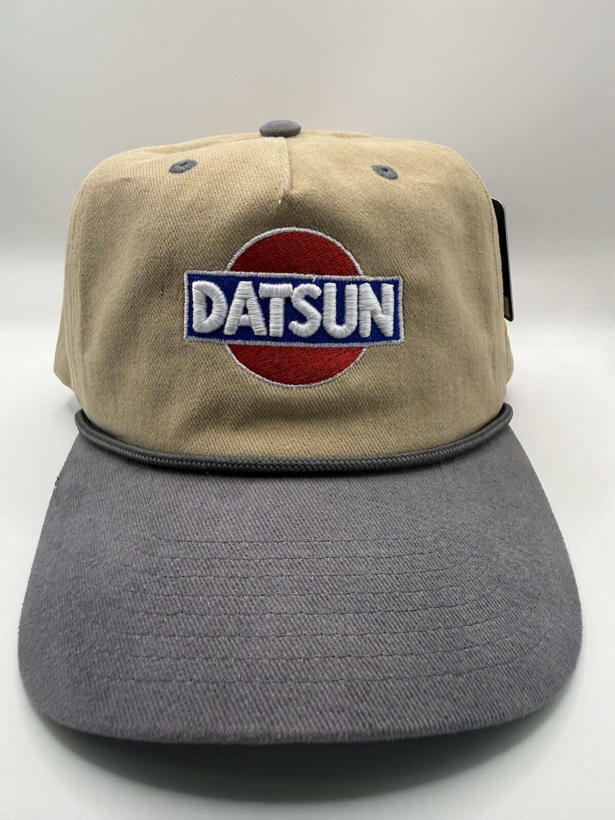 Car enthusiast logo embroidered on a tan rope cap with CJ on the side