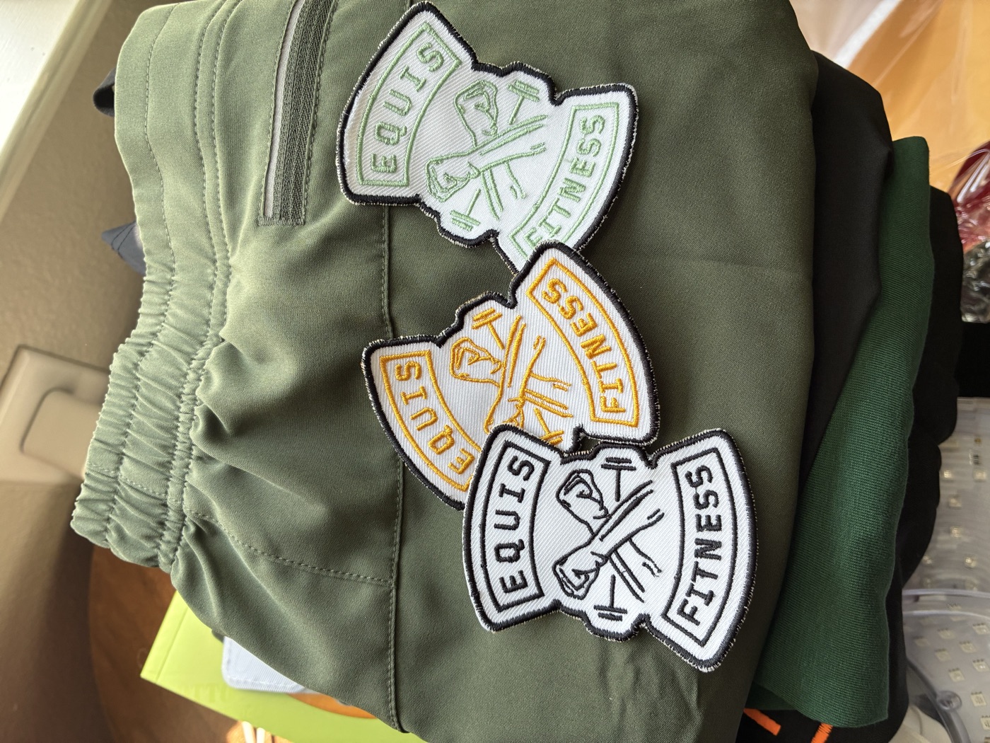 Equis Fitness patches on a jacket