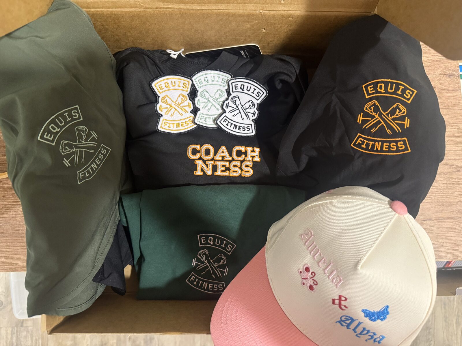 Equis Fitness team order: embroidered jackets, tees, patches and a Coach Ness shirt