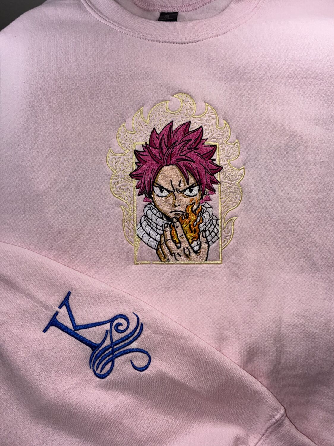 Anime character embroidered on a pink crewneck sweatshirt