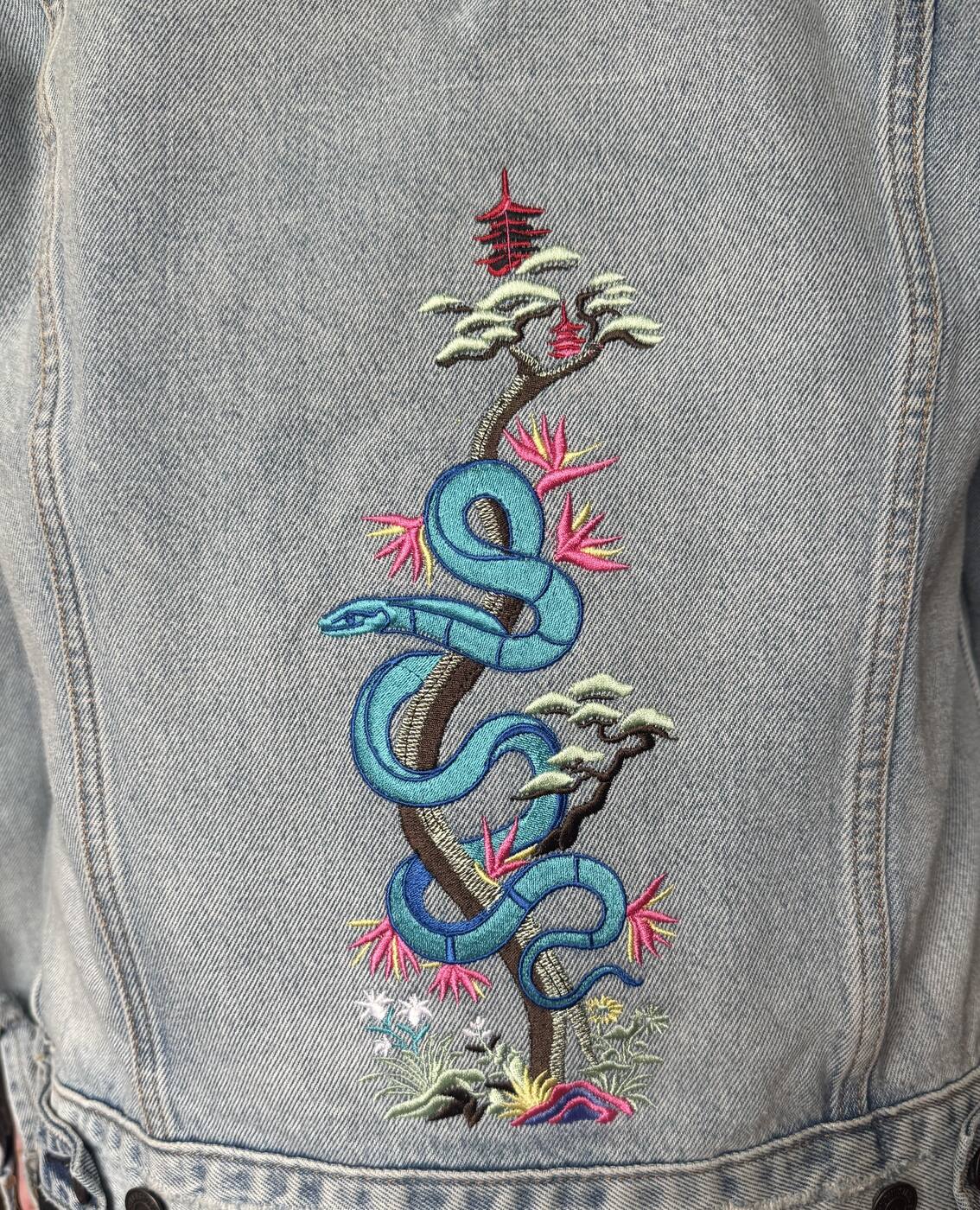 Snake and bonsai tree embroidered on a denim jacket